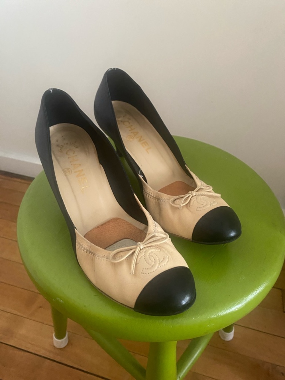 CHANEL Beige Leather Pumps with Black Cap Toe and Bow